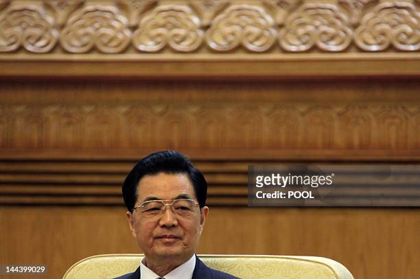 China's President Hu Jintao attends a meeting with his South Korean counterpart Lee Myung-bak and Japan's Prime Minister Yoshihiko Noda during the...