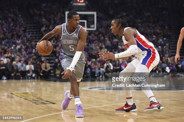 De'Aaron Fox of the Sacramento Kings dribbles the ball against Jaden Ivey of the Detroit Pistons in the first quarter at Golden 1 Center on November...