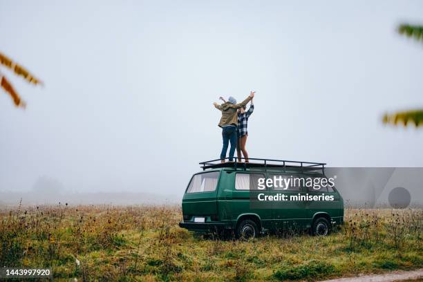 unrecognizable couple having fun while standing on a van - fog camper stock pictures, royalty-free photos & images