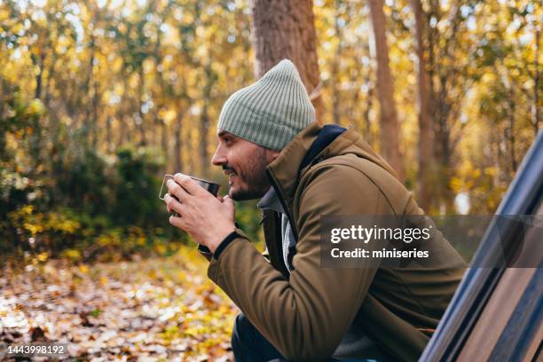 happy man relaxing in a hammock - man coat stock pictures, royalty-free photos & images