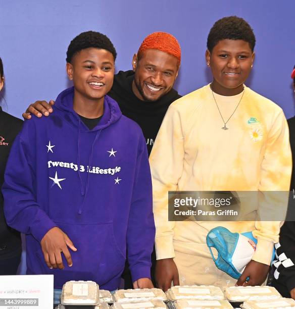 Usher Raymond and his sons Usher "Cinco" Raymond V and Naviyd Raymond attend the Healthy Thanksgiving meals giveaway event hosted / sponsored by...