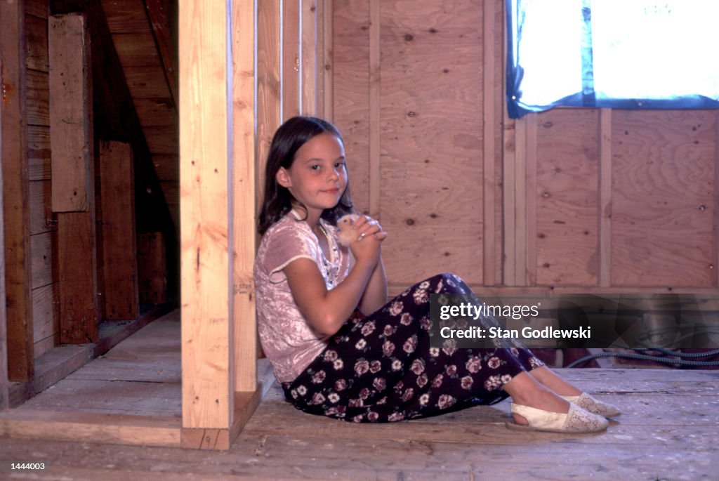 Meghan Holman, age 7, holds her hamster, Snowball...