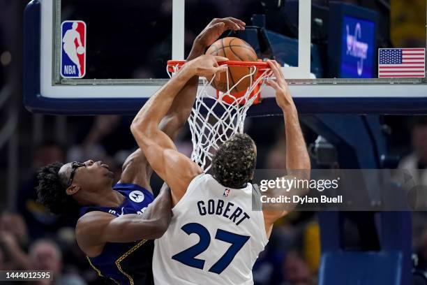 Rudy Gobert of the Minnesota Timberwolves dunks the ball past Jalen Smith of the Indiana Pacers in the first quarter at Gainbridge Fieldhouse on...
