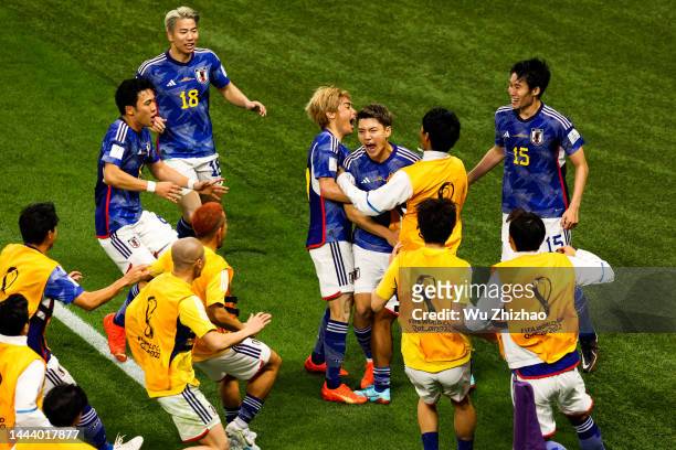 Ritsu Doan of Japan celebrates with team mates after scoring his team's first goal during the FIFA World Cup Qatar 2022 Group E match between Germany...