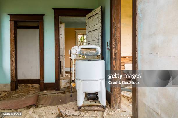 retro style washing machine in an abandoned house - antique washing machine stock pictures, royalty-free photos & images
