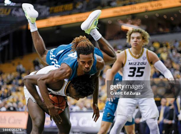 Kobe Brown of the Missouri Tigers is fouled by Josh Uduje of the Coastal Carolina Chanticleers as he tries to score in the second half at Mizzou...