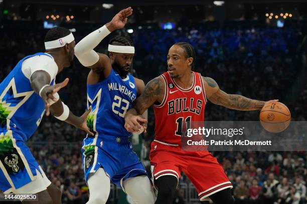 DeMar DeRozan of the Chicago Bulls dribbles the ball against Wesley Matthews of the Milwaukee Bucks during the first half at Fiserv Forum on November...