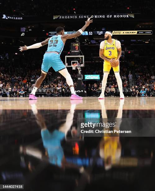 Anthony Davis of the Los Angeles Lakers handles the ball against Deandre Ayton of the Phoenix Suns during the second half of the NBA game at...