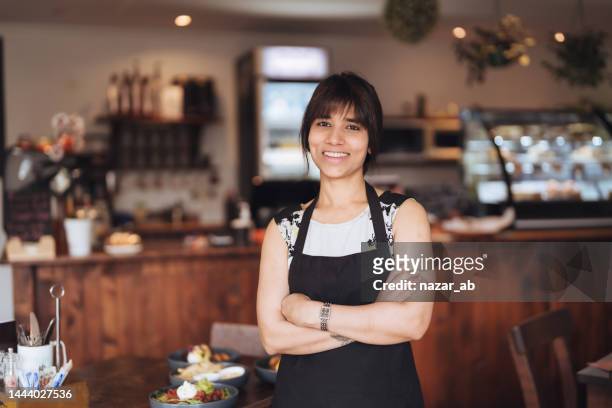 happy female cafe owner looking at camera. - new zealand small business stock pictures, royalty-free photos & images