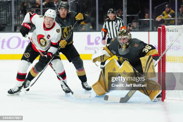 Zach Whitecloud of the Vegas Golden Knights and Brady Tkachuk of the Ottawa Senators battle in front of the net as Logan Thompson defends during the...