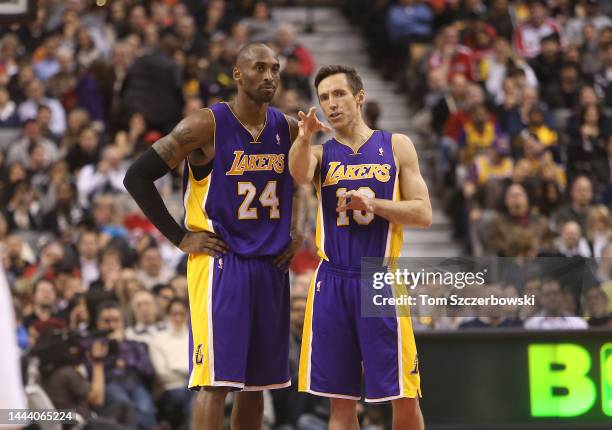 Steve Nash of the Los Angeles Lakers talks to Kobe Bryant against the Toronto Raptors during NBA game action on January 20, 2013 at Air Canada Centre...