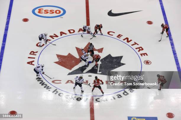 General view of the opening face-off at center ice between Canada and USA featuring a large Hockey Canada logo during the first period in an...