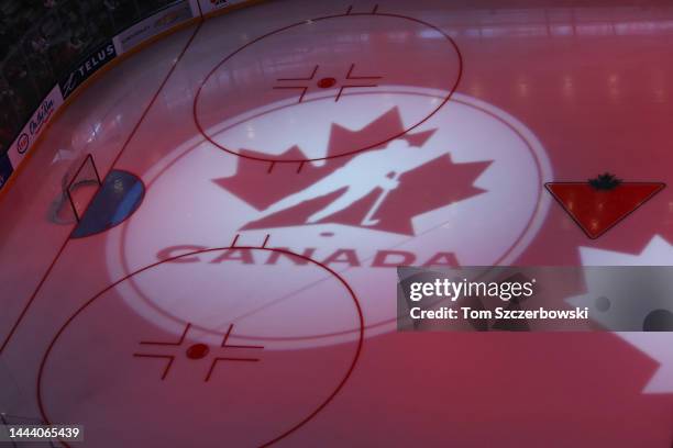 The Hockey Canada logo and the Canadian Tire logo are projected onto the ice during a light show before the start of an exhibition women's hockey...