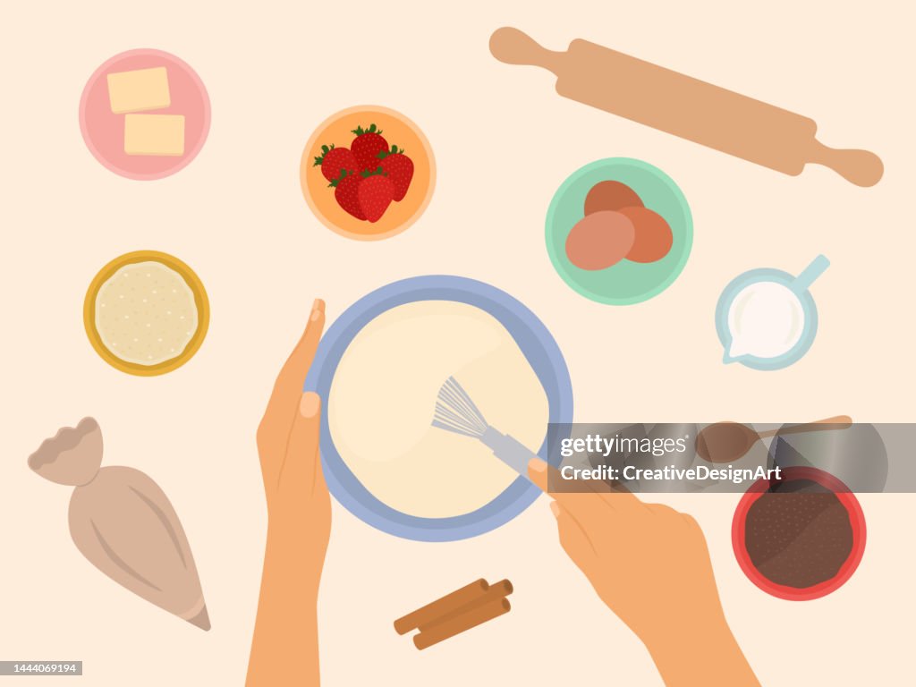 Top View Of Hands Holding Whisk And Mixing Ingredients In Bowl To Bake Cake. Flour, Eggs, Rolling Pin And Other Equipments On Table