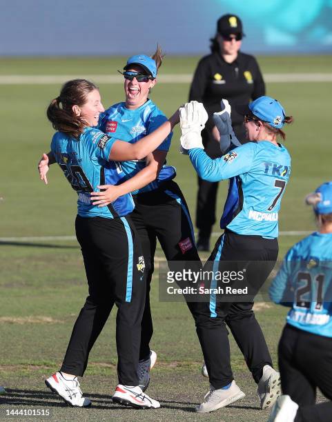 Darcie Brown of the Adelaide Strikers with Madeline Penna of the Adelaide Strikers and Tegan McPharlin of the Adelaide Strikers after bowling Georgia...