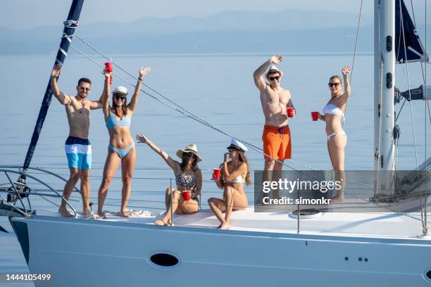 friends enjoying party on sailboat - boat party stock pictures, royalty-free photos & images