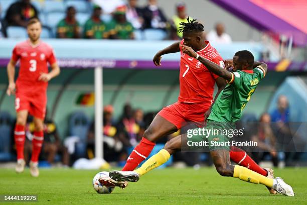 Breel Embolo of Switzerland and Nicolas Nkoulou of Cameroon battle for the ball during the FIFA World Cup Qatar 2022 Group G match between...