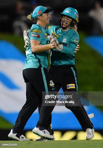 Nicola Hancock of the Brisbane Heat celebrates after catching the wicket of Katie Mack of the Adelaide Strikers with Georgia Redmayne of the Brisbane...