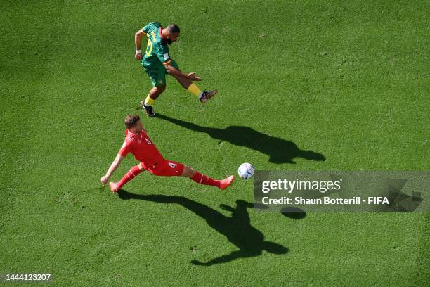 Nico Elvedi of Switzerland and Bryan Mbeumo of Cameroon compete for the ball during the FIFA World Cup Qatar 2022 Group G match between Switzerland...