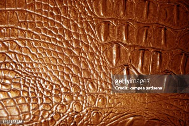 textured background of genuine leather in crocodile skin pattern - mottled skin stockfoto's en -beelden