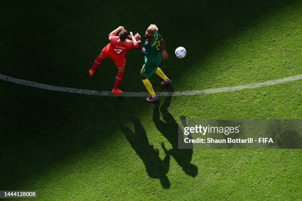 Nico Elvedi of Switzerland competes for a header against Eric Maxim Choupo-Moting of Cameroon during the FIFA World Cup Qatar 2022 Group G match...