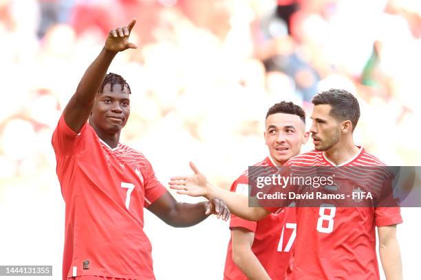 Breel Embolo of Switzerland celebrates scoring their first goal with their teammates Ruben Vargas and Remo Freuler during the FIFA World Cup Qatar...