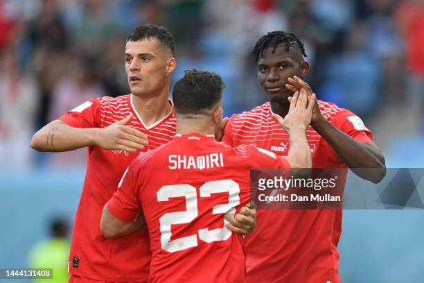 Breel Embolo of Switzerland celebrates scoring their first goal with their teammates Granit Xhaka and Xherdan Shaqiri during the FIFA World Cup Qatar...