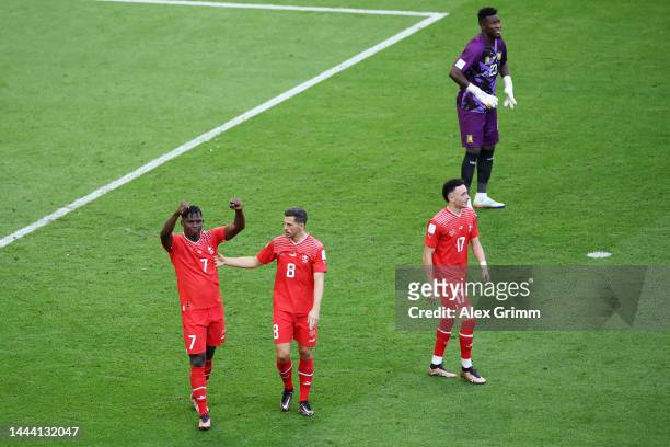 Breel Embolo of Switzerland celebrates scoring their first goal with their teammates Ruben Vargas and Remo Freuler during the FIFA World Cup Qatar...