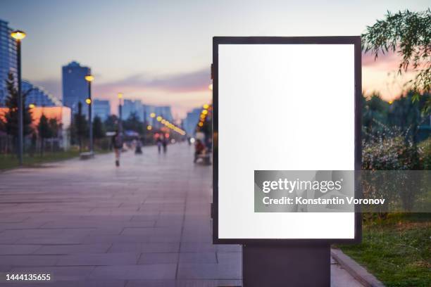 blank city format (lightposter, citylight) banner pylon on the public park mockup. evening illumination, street lighting - poster template stock pictures, royalty-free photos & images