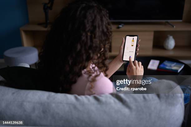 woman shopping online with smartphone - online shopping stock pictures, royalty-free photos & images