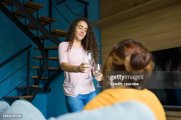 female friends talking and drinking at home - compras online stock pictures, royalty-free photos & images