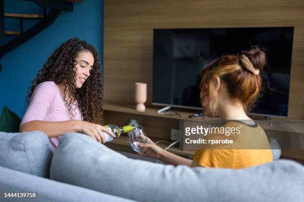 female friends talking and drinking at home - compras online stock pictures, royalty-free photos & images