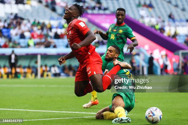 Breel Embolo of Switzerland and Jean-Charles Castelletto of Cameroon compete for the ball during the FIFA World Cup Qatar 2022 Group G match between...