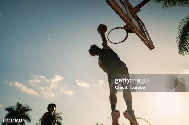 basketball player making play - street basketball stockfoto's en -beelden