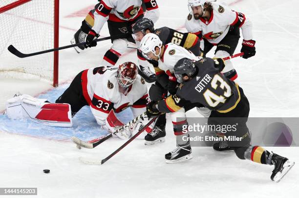 Cam Talbot and Artem Zub of the Ottawa Senators defend the net as Paul Cotter and Michael Amadio of the Vegas Golden Knights look for a rebound off...