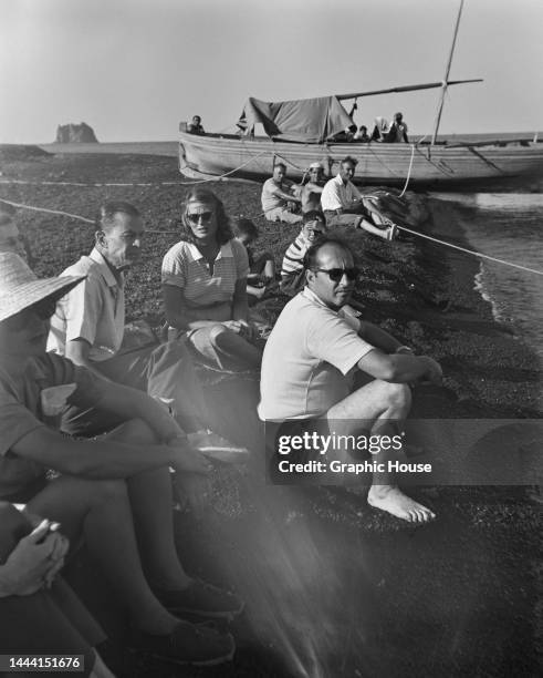 Swedish actress Ingrid Bergman and Italian film director and screenwriter Roberto Rossellini among people during a break in filming for the film...