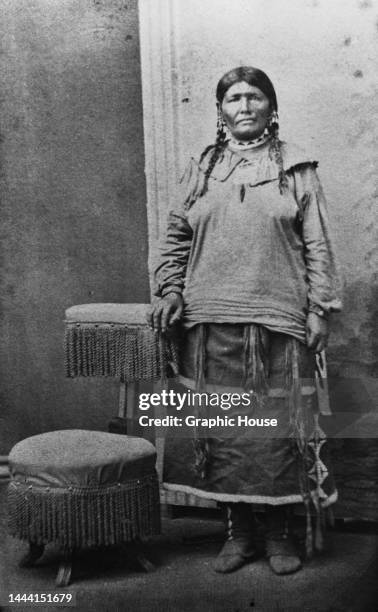 Osage woman named Wincombone poses beside a fringed footstool, United States, circa 1860. The Osage are a Midwestern Native American tribe of the...