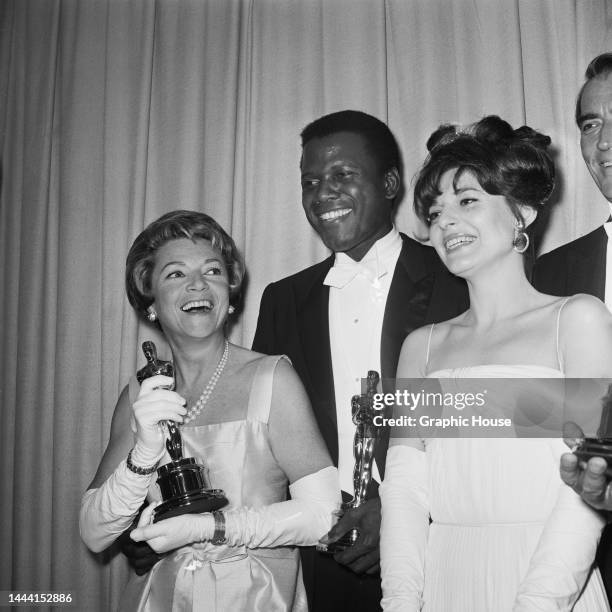 French actress Annabella , Afro-Bahamian actor Sidney Poitier , and American actress Anne Bancroft in the press room of the 36th Academy Awards...