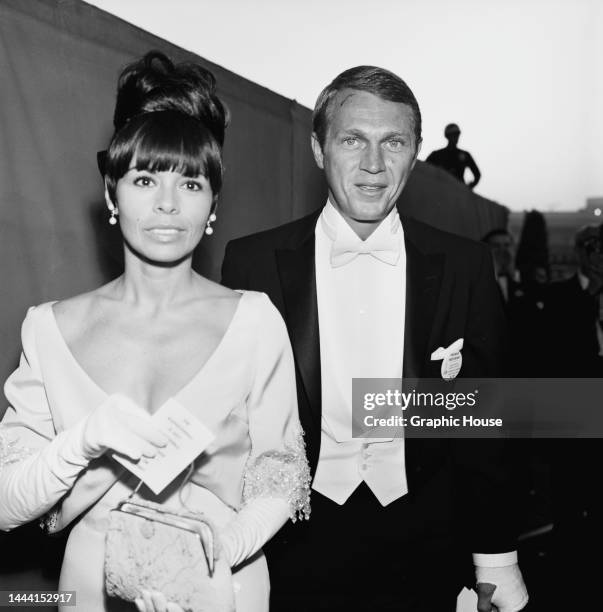 Filipina-American singer, actress and dancer Neile Adams and her husband, American actor Steve McQueen attend the 36th Academy Awards ceremony, held...