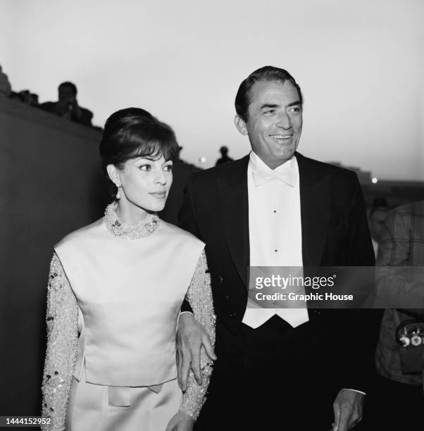 French journalist Veronique Peck and her husband, American actor Gregory Peck , attend the 36th Academy Awards ceremony, held at the Santa Monica...