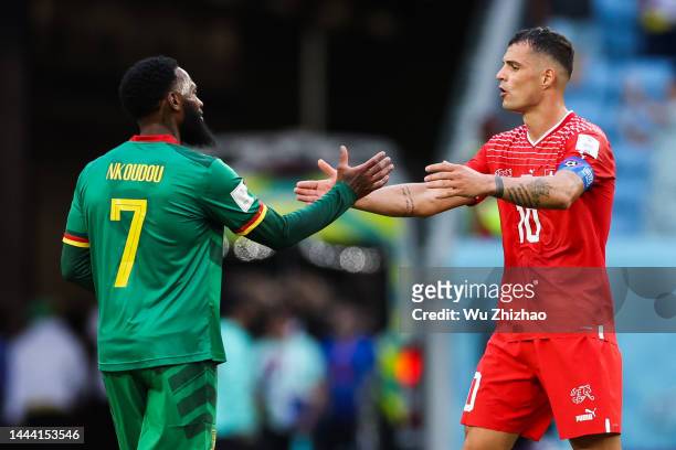 Granit Xhaka of Switzerland shakes hands with Georges-Kevin Nkoudou of Cameroon after the FIFA World Cup Qatar 2022 Group G match between Switzerland...