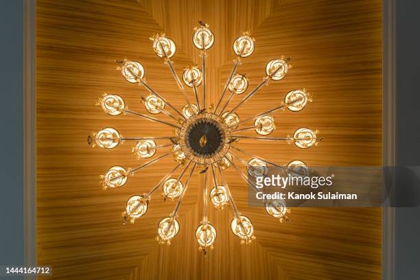 low angle view of illuminated light hanging from wooden ceiling - looking up vintage stock pictures, royalty-free photos & images