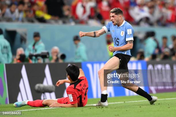 Federico Valverde of Uruguay reacts after a tackle on Kangin Lee of Korea Republic during the FIFA World Cup Qatar 2022 Group H match between Uruguay...