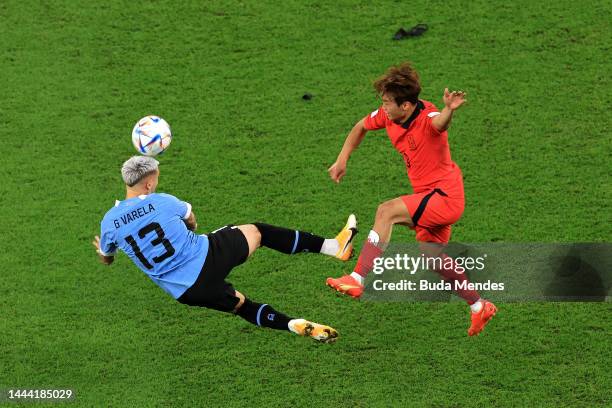 Guillermo Varela of Uruguay battles for possession with Jinsu Kim of Korea Republic during the FIFA World Cup Qatar 2022 Group H match between...