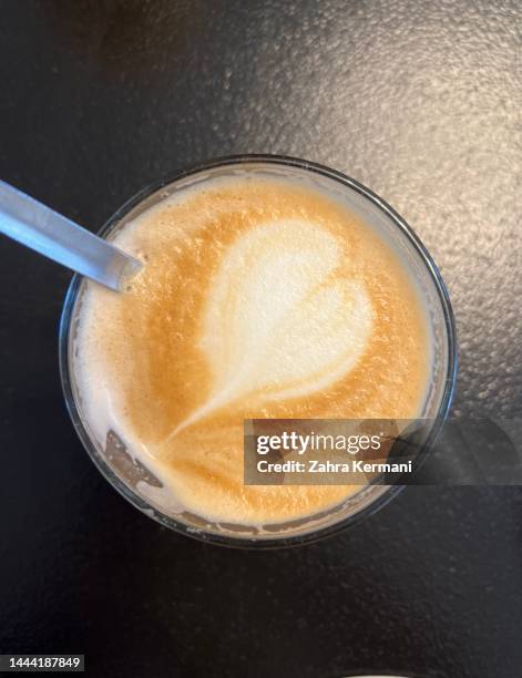 Close up photo of coffee in a glass cup on a black background close up photo coffee glass cup