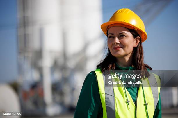 portrait of female engineer with hardhat at factory industry workplace - hardhat outside bildbanksfoton och bilder