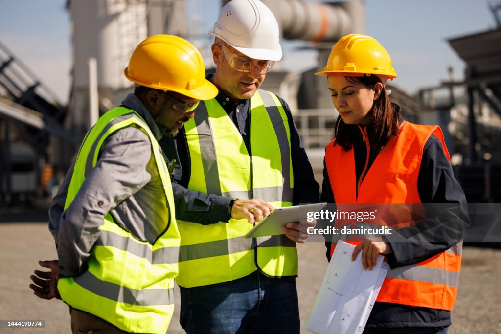 Engineers discussing at industrial facility