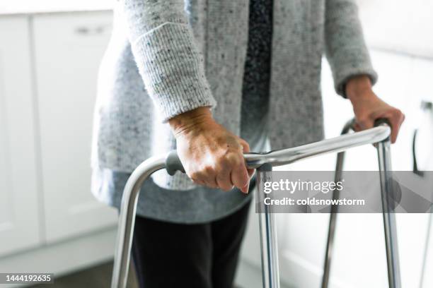 senior woman using walker at home - outpatient care stock pictures, royalty-free photos & images