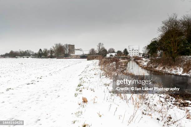 wickhambreaux, kent, england, uk. 8 february 2021. distant view of wickhambreaux church and watermill in the snow. - south east england stock pictures, royalty-free photos & images