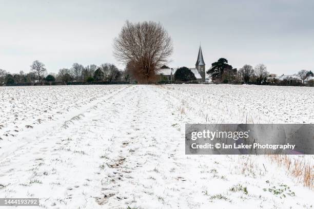 ickham, kent, england, uk. 8 february 2021. distant view of ickham church in the snow. - south east england stock pictures, royalty-free photos & images